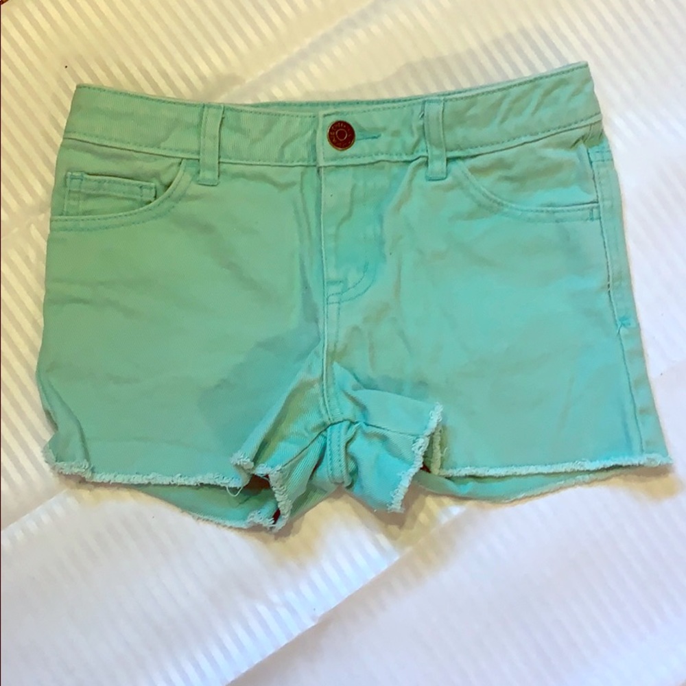 Youth teal blue shorts with drilled bottom edges
